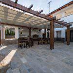 Beautiful terrace lounge with pergola and wooden table with chairs